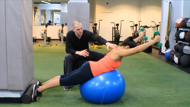 The pictured exercise, Prone Ball Combo (Trapezius Activation) is being performed in a prone position on a stability ball.