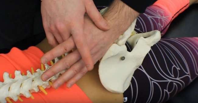 Explanation of hand position during a sacroiliac joint mobilization using a pisiform (saddle) grip hand position.