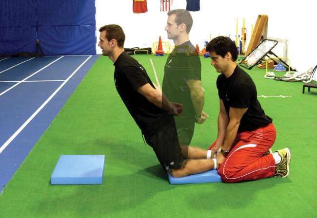 Image of Trainer and Client performing the Noric Curl a.k.a the Nordic Hamstring Curl