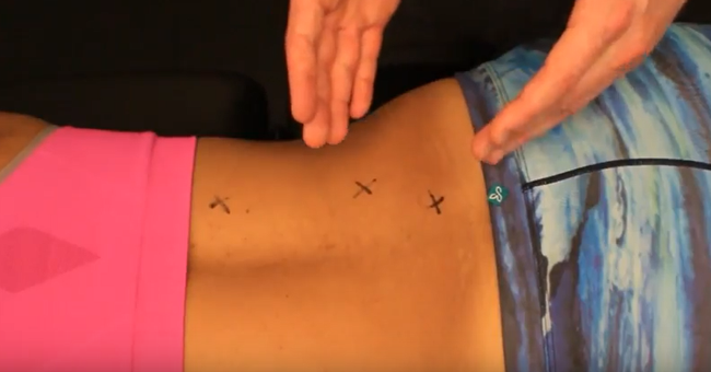 Dr. Brent Brookbush points out erector spinae and multifidus trigger points before demonstrating manual static release techniques.