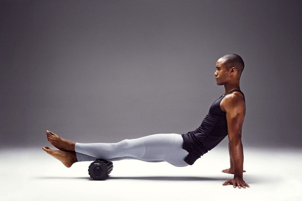 Photograph of an athlete using the viper foam roll on calf